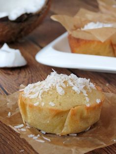 a muffin with coconut on top and another muffin in the background