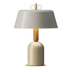 a table lamp with a white shade on it and a wooden stick sticking out of the base