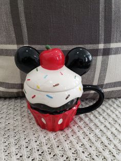 a mickey mouse cupcake with a cherry on top