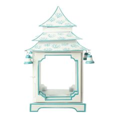 a white and blue bird house with bells on it's roof, sitting in front of a white background