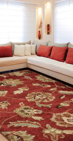 a living room area with couches and rugs