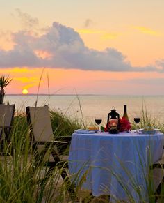 a table set up on the beach for dinner