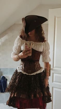 a woman in a pirate costume taking a selfie