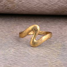 Unique Wave Ring Gold, Womens Oceans Wave Ring, Trendy Ocean Sea Wave Ring Brass, Women's Trendy Waves Brass Band SIZE :- All Size Are Available, choose from variation. METAL :- Brass ❥ Customers satisfaction is our biggest priority, please contact us with any questions/queries for future or existing orders, and we will do our best to make sure you are happy with your order. ♥ Please Make Sure to Include The Correct Address During Before Order. You Can return Item within 30 Days After Successful Vintage Metal Midi Rings As Gift, Vintage Handmade Gold Stackable Rings, Handmade Vintage Gold Stackable Rings, Vintage Metal Toe Ring Midi Rings, Hand Forged Rings As Gift, Vintage Hand Forged Metal Rings, Vintage Metal Toe Ring, Ocean Gold Ring, Handmade Ocean-inspired Rings