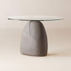 a round glass table with a rock like base