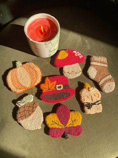 crocheted coasters are arranged on a table next to a candle