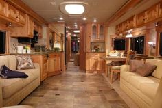 the interior of a recreational vehicle with wood trim and tile flooring is shown in this image