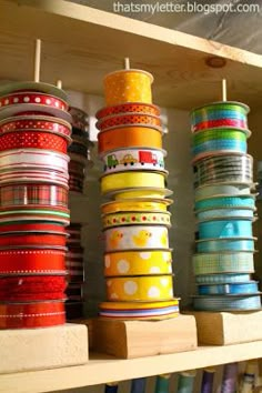 several stacks of brightly colored ribbons on a shelf