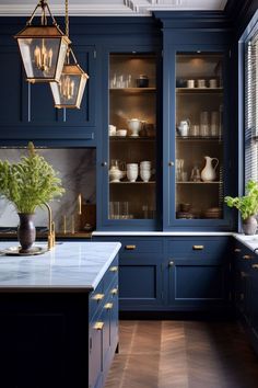 a kitchen with dark blue cabinets and gold trimmings, white marble counter tops