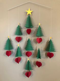 a group of paper christmas trees hanging on a wall