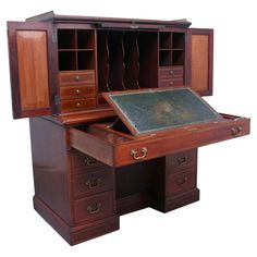 an old wooden desk with drawers and a chalkboard