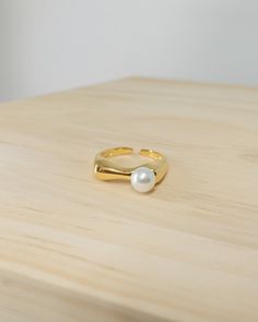 minimal open ring featuring single freshwater pearl with fluid band design yellow gold vermeil over 925 sterling silver freshwater pearl size 6.1mm in diameter high shine polished ring band open design total weight 2.43g Pearl Pinky Ring, Jewelry Minimal, Minimal Ring, Band Design, Jewelry Lookbook, Open Design, Pinky Ring, Open Ring, Pearl Size