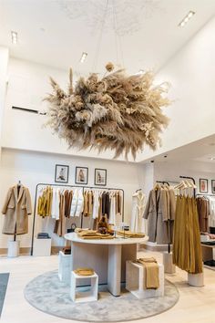 the inside of a clothing store with clothes on display