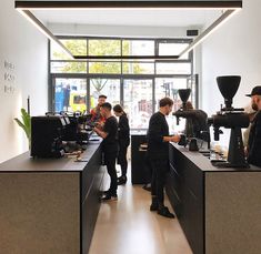 several people are standing in the coffee shop