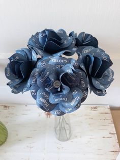 a vase filled with blue flowers on top of a table