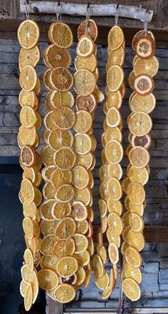 orange slices hanging from hooks in front of a fireplace