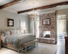 a bedroom with a brick fireplace and bed