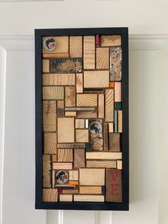 a piece of art made out of wooden planks hanging on a white door frame