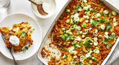 a casserole dish with vegetables and cheese on the side