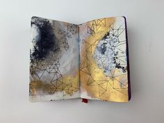 an open book with abstract designs on it