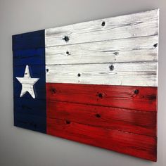 an american flag painted on wooden planks in the shape of a texas state flag