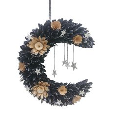 a black wreath with flowers and stars hanging from it