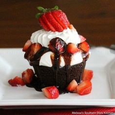 strawberry shortcake brownie cupcakes with chocolate frosting and strawberries on top