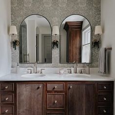 a bathroom with two sinks and three mirrors on the wall next to eachother