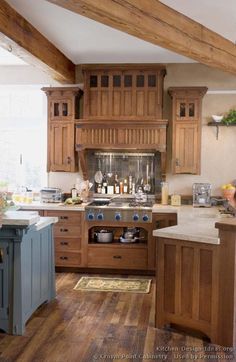 a large kitchen with wooden cabinets and an island in the middle of it, surrounded by wood beams