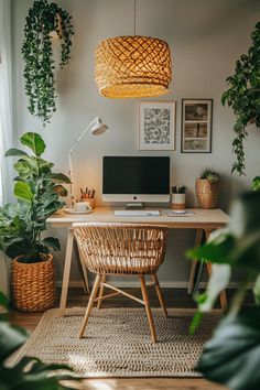 a desk with a computer and some plants