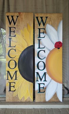 two wooden signs with the words welcome, welcome and sunflowers painted on them