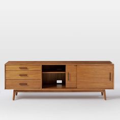 the sideboard is made out of wood and has two drawers, one with an open door