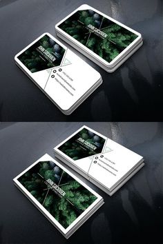 three business cards with green plants on them, all in white and black colors are shown