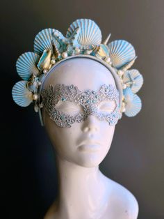 The mermaid crown headband boasts a captivating shade of turquoise that evokes the tranquil depths of the sea. Delicate pearls and sea shell details adorn the crown, adding a touch of oceanic charm and grace. Golden accents add an opulent touch, mirroring the treasures of the sea. This enchanting pairing ensures you'll be the center of attention at masquerade events!


Age Group/Gender - Adult/Women

Size/Type - One size fits all adults

Color - Turquoise/Gold/Silver

Mask Material - Lace

Accen Blue Ocean-inspired Shell For Summer, Mermaid Mask, Labyrinth Ball, Crown Costume, Pearl Mask, Silver Mask, Arts And Crafts For Adults, Mermaid Crown, Rainbow Magic