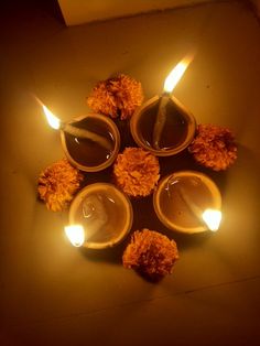 small candles are lit in the shape of pom poms on a brown surface