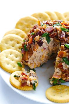 a white plate topped with crackers covered in food