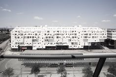 an aerial view of a white building with lots of windows