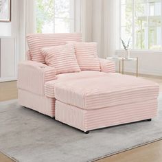 a pink chair and ottoman in a living room