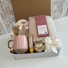 a gift box with coffee, candles and other items