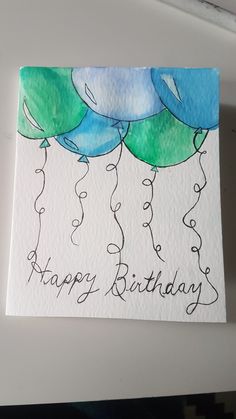 a birthday card with blue and green balloons