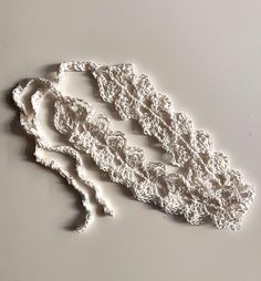 a piece of white crochet sitting on top of a table