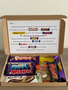 an open box filled with candy on top of a wooden table