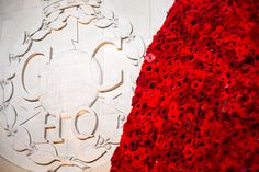 a red and white flowered wall next to a building with the number 101 on it