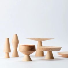 several wooden objects are arranged in the shape of small trees and vases on white background