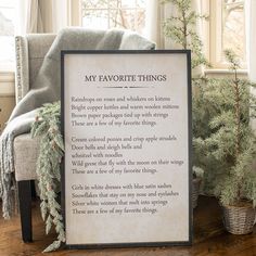 a framed poem sitting on top of a wooden floor next to a chair and christmas tree