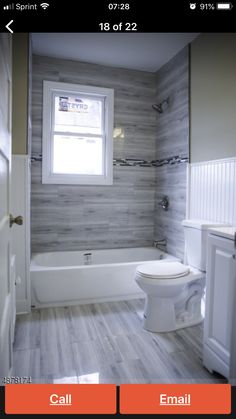 a white toilet sitting next to a bath tub in a bathroom on top of a wooden floor