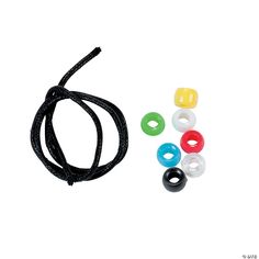 an assortment of different colored beads on a black cord with white and yellow circles around it