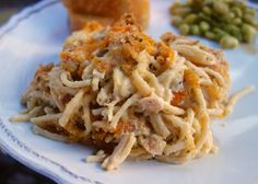 a white plate topped with pasta and green beans