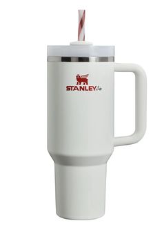 a white travel mug with a straw in the top and stanley logo on the side