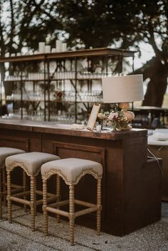 the bar has four stools and a lamp on it